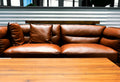 brown leather two-seat sofa