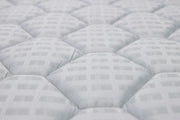 Close-up of a white quilted mattress texture