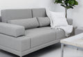 Modern gray sofa with throw blanket and pillow.