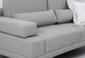 A modern gray sofa with throw pillows and blanket